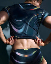 Black mesh swim trunks with vibrant iridescent rainbow swirl pattern for men’s pride and rave confidence apparel