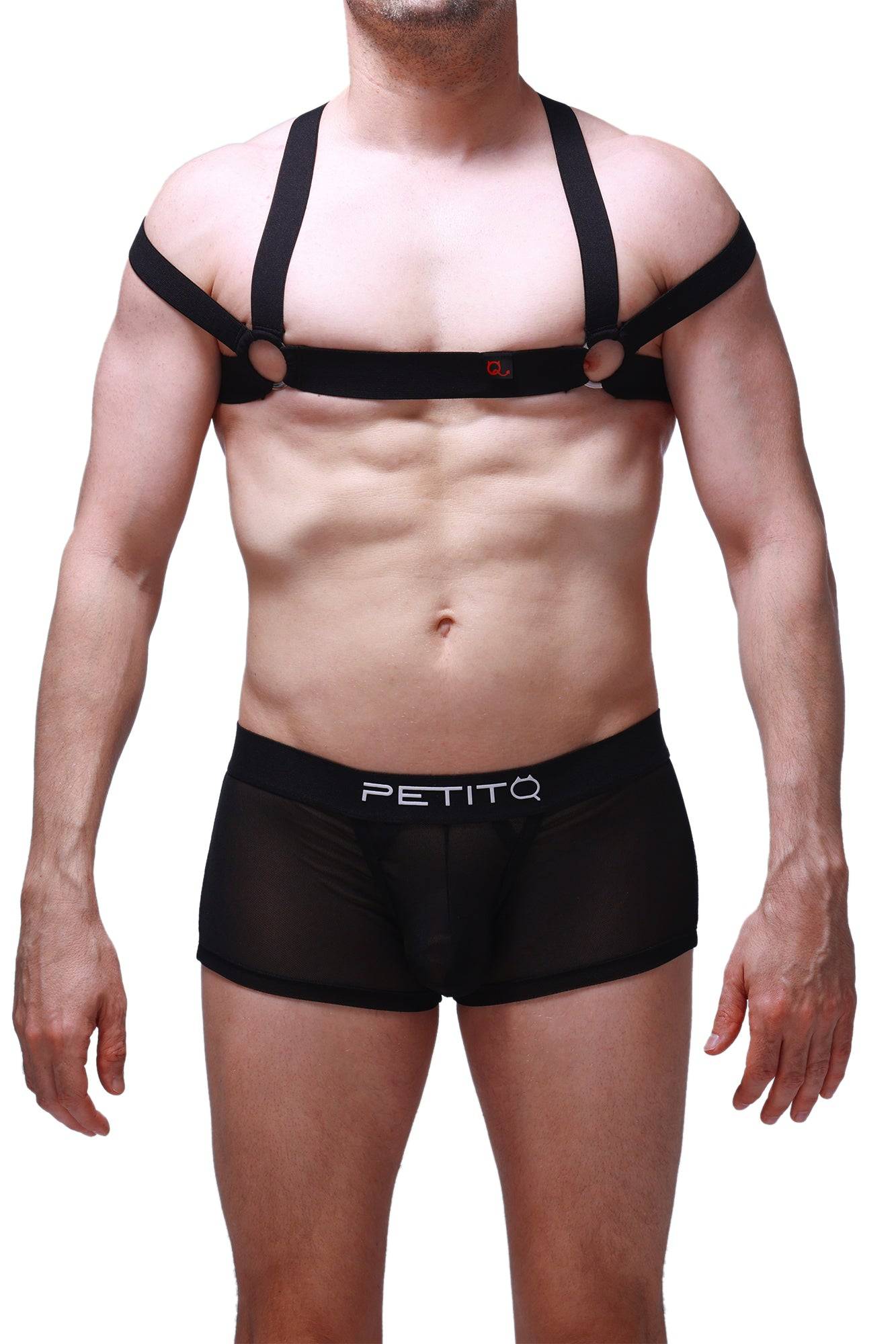 Man wearing black mesh shorts with "PETITQ" logo and chest harness.