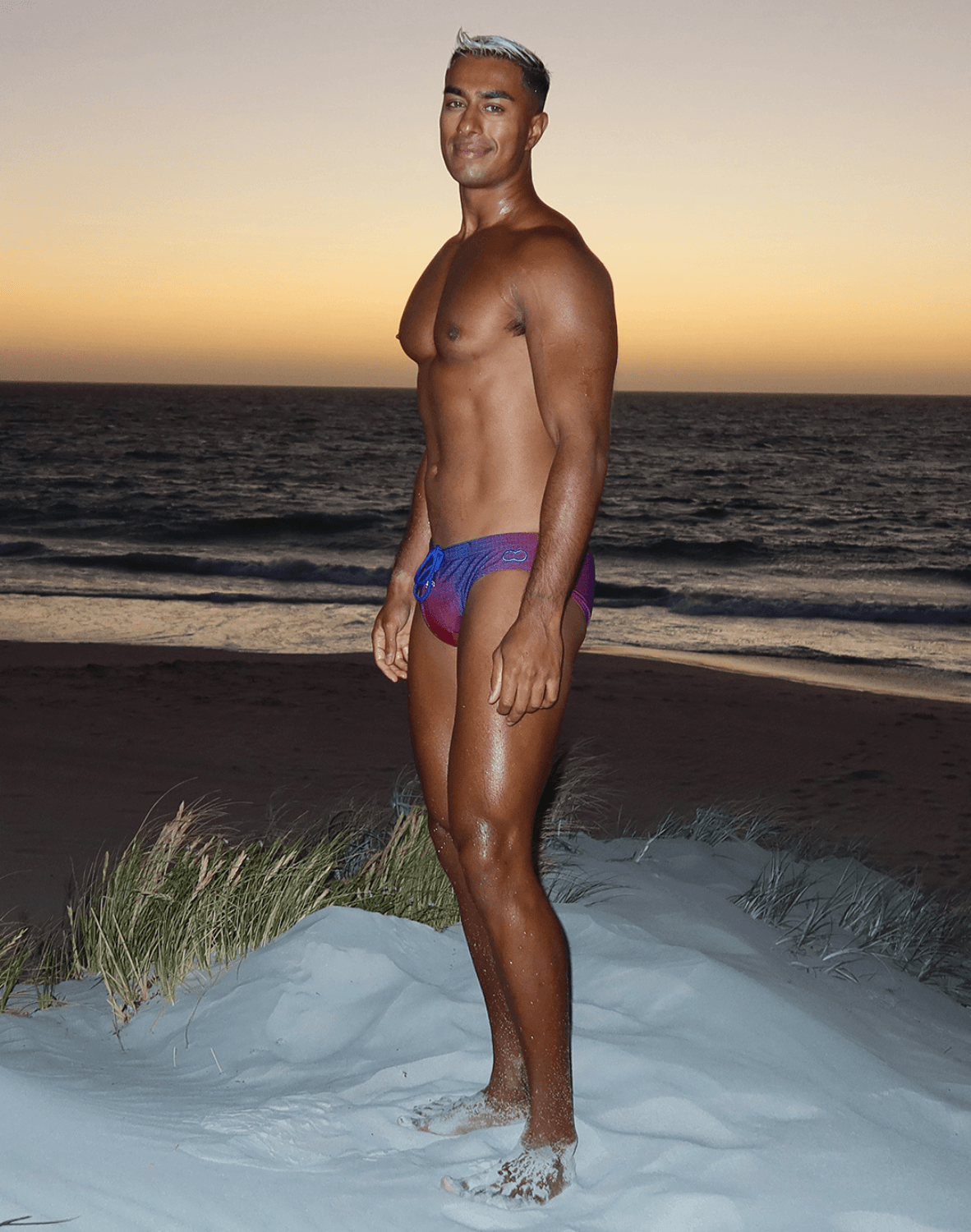 Vibrant gradient swim trunks in purple and blue with a sleek modern design from the swimwear collection