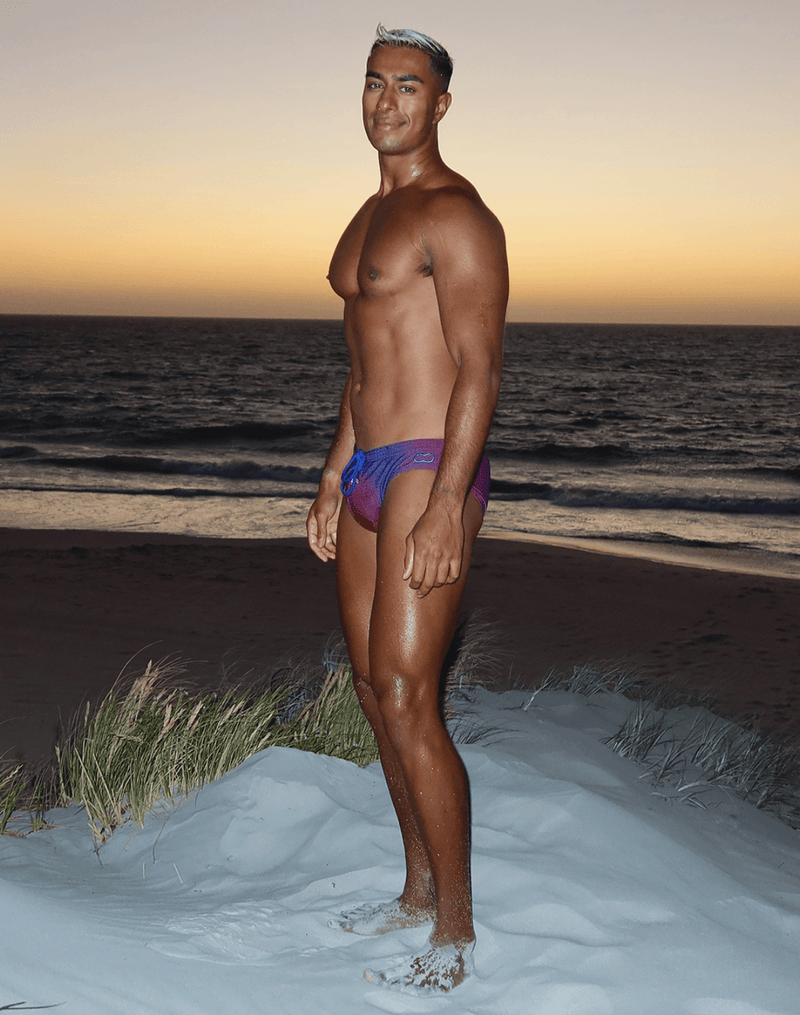 Vibrant gradient swim trunks in purple and blue with a sleek modern design from the swimwear collection