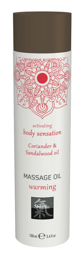 White cylindrical massage oil bottle with brown cap and red mandala labeled coriander and sandalwood oil