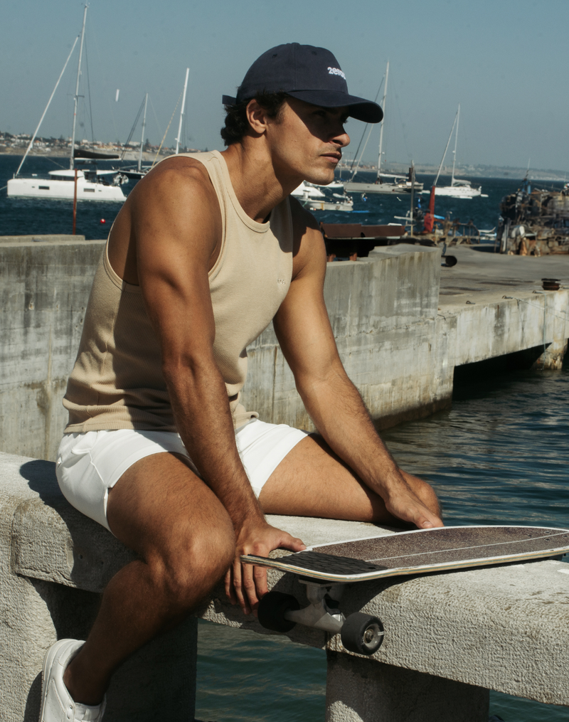 Navy blue baseball cap with white logo front view in tank tops and vests collection for casual wear