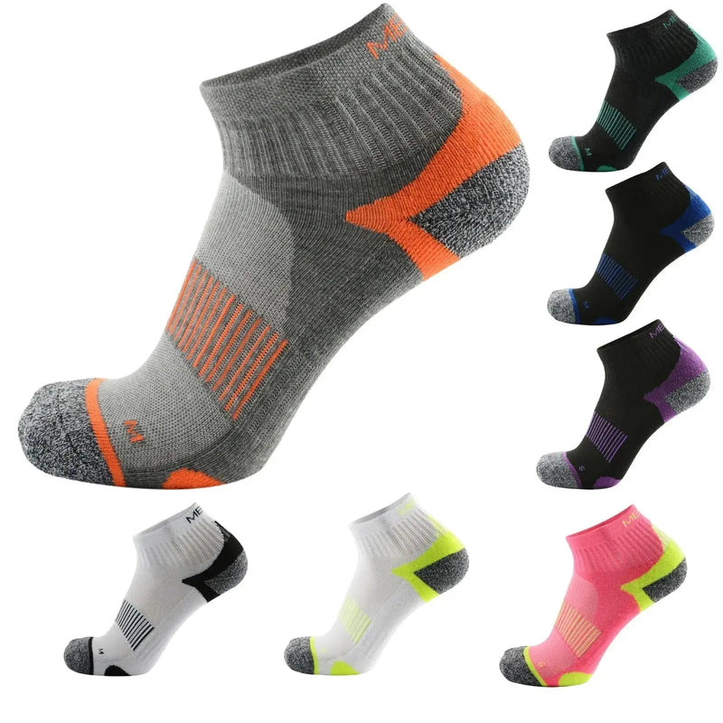 Grey and orange ankle socks displayed against a clean white studio background.