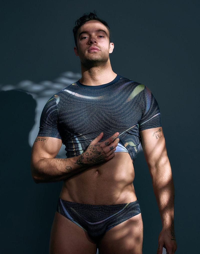Dark blue textured short-sleeve top with iridescent swirls and subtle sheen from the SUPAWEAR collection