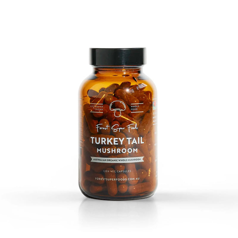 Amber glass bottle filled with brown capsules, featuring a white label, isolated.