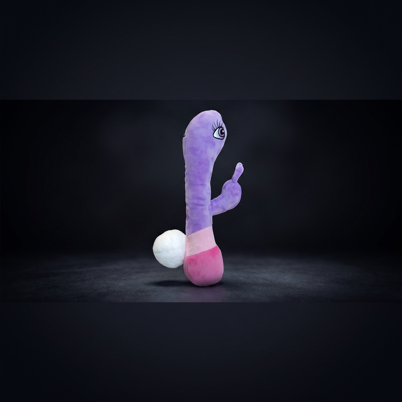 Boneyard novelty plush mascot — purple and pink character figure with cartoon eye, shot against dark studio backdrop.