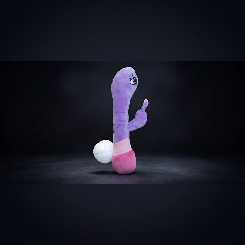 Boneyard novelty plush mascot — purple and pink character figure with cartoon eye, shot against dark studio backdrop.
