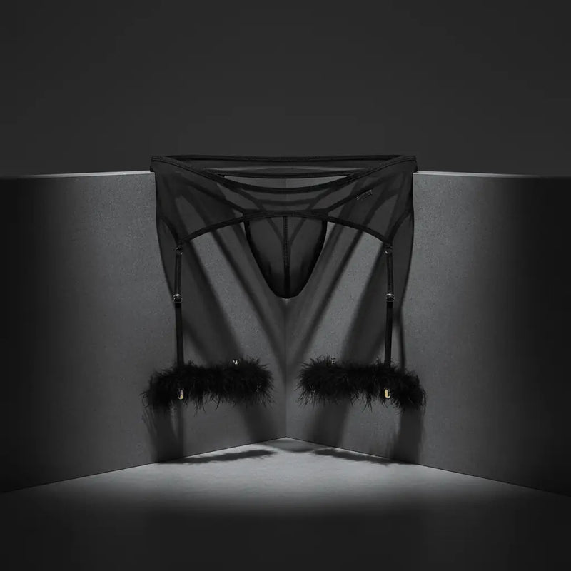 CandyMan Fashion men's underwear featuring a bold black design with feather accents against a dark background.