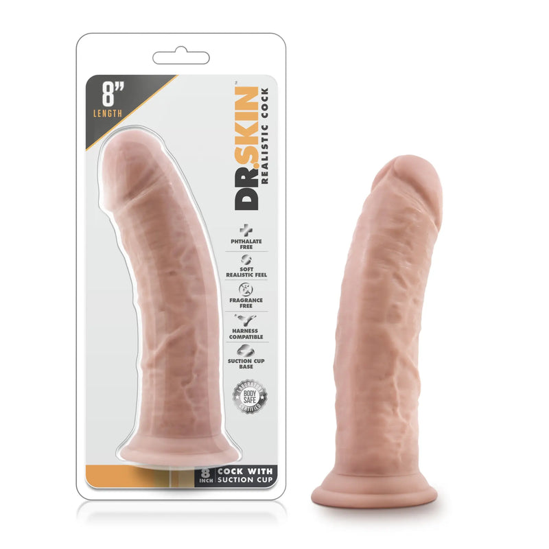 A pink textured phallic silicone object with a suction base stands upright.