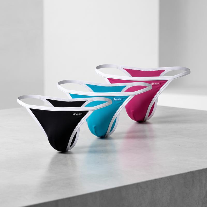 Groovin' Underwear string briefs with white contrast trim in three colourways — pink, black, and teal.