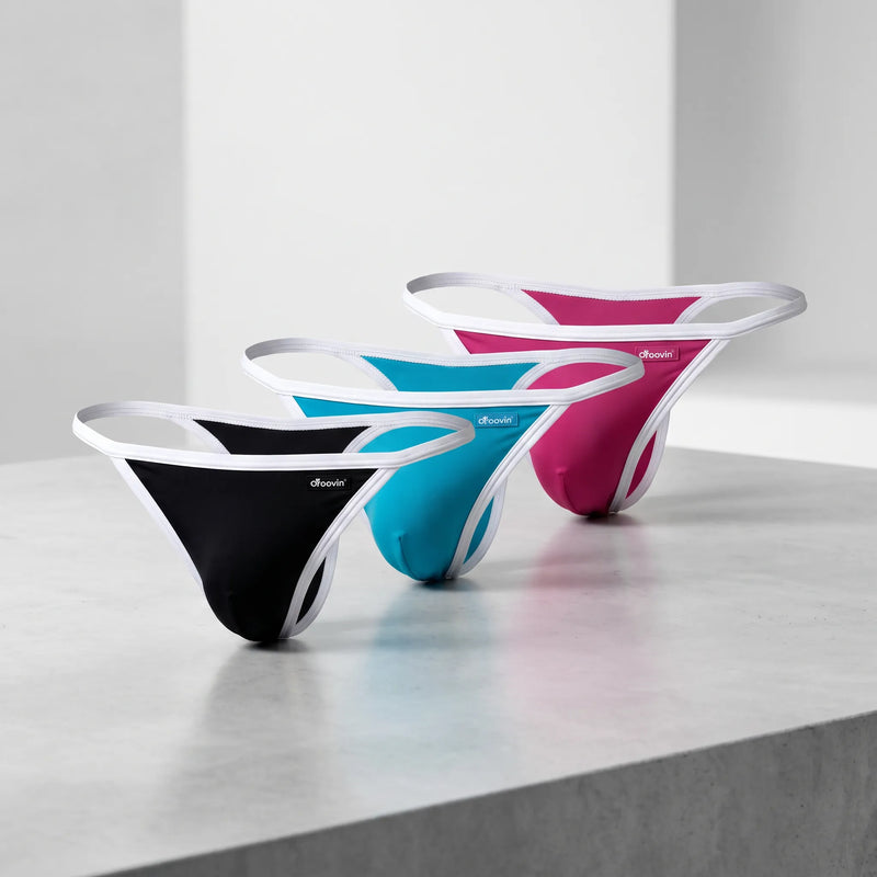 Groovin' Underwear string briefs with white contrast trim in three colourways — pink, black, and teal.