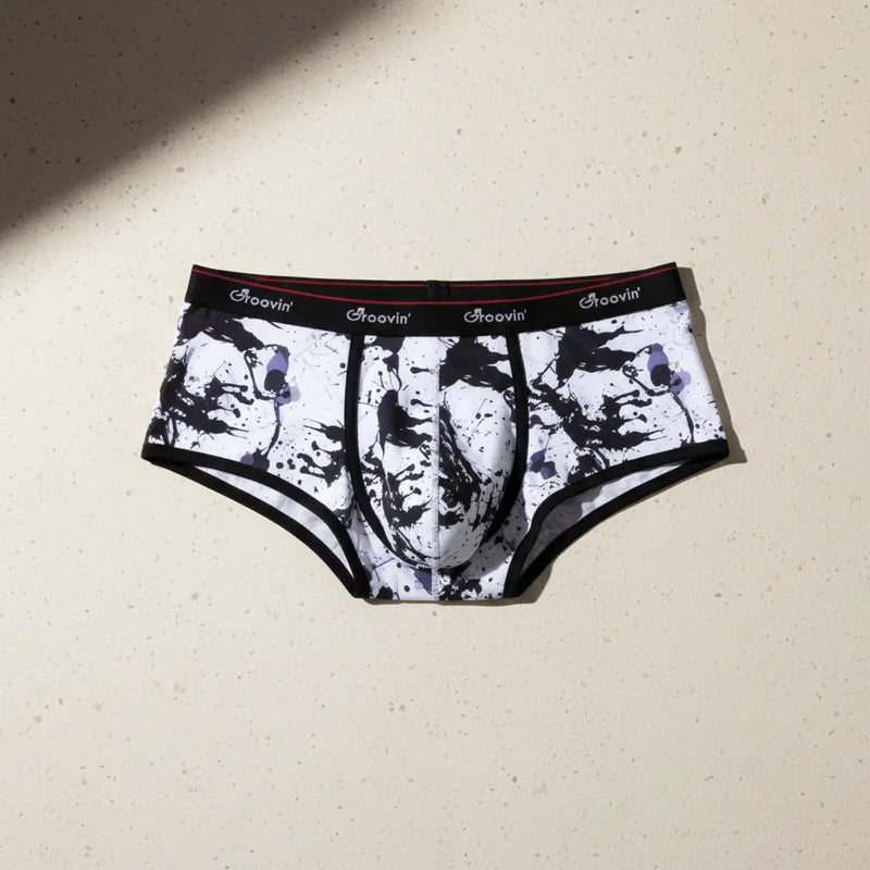 Groovin' Underwear men's brief with bold black and white design on a beige background.