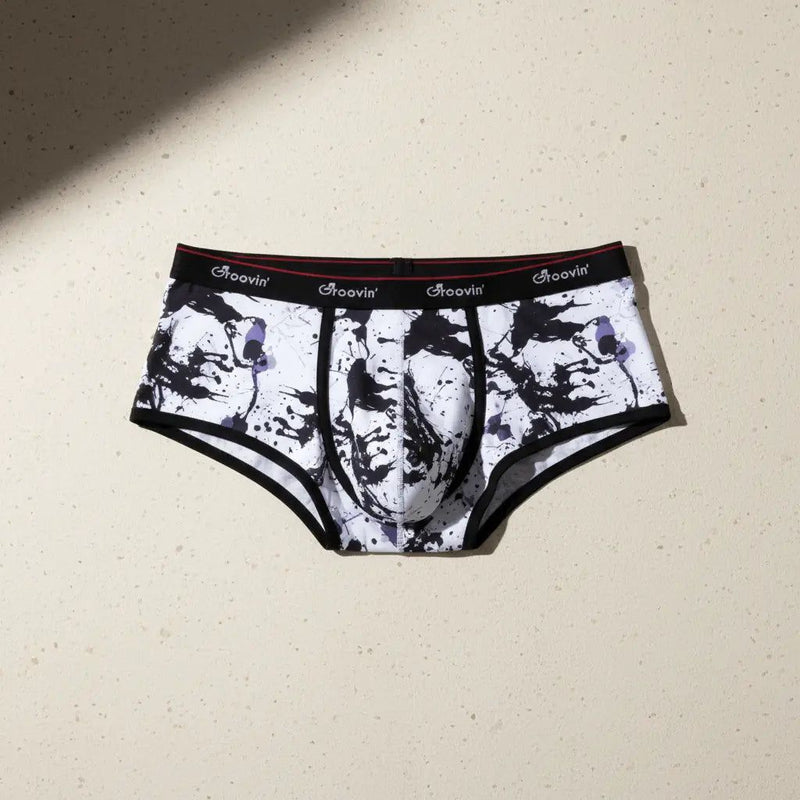 Groovin' Underwear men's brief with bold black and white design on a beige background.
