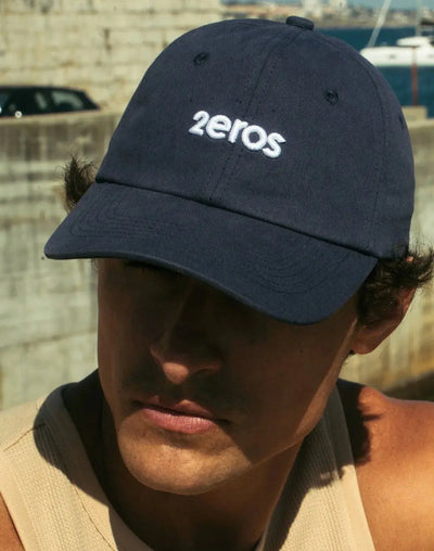 Navy blue baseball cap with white embroidered 2eros logo from the Hats Masks and Scarves collection