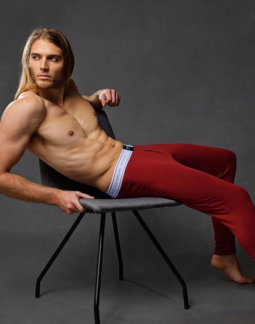 Red athletic leggings with a white calvin klein waistband designed for casual wear