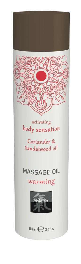 White cylindrical massage oil bottle with brown cap and red mandala labeled coriander and sandalwood oil