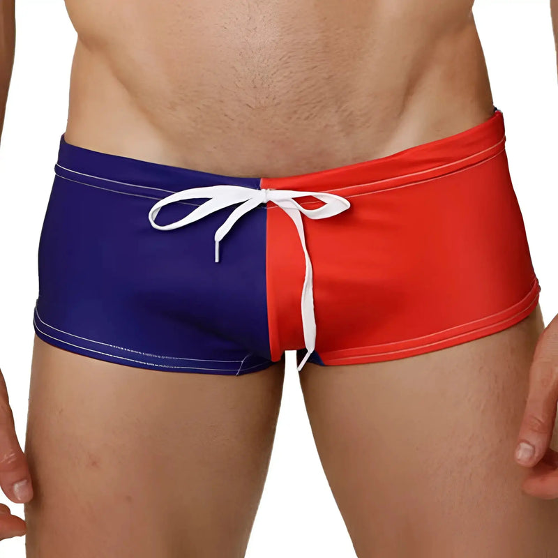 Close-up of smooth, dark blue and red swim trunks with a white drawstring.