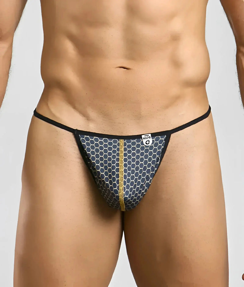 A man models blue patterned low-rise briefs featuring thin black side straps.