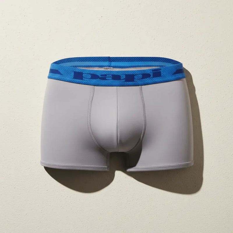 Papi Underwear men's gray Brazilian trunk with blue waistband on a neutral background.
