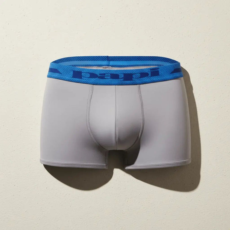 Papi Underwear men's gray Brazilian trunk with blue waistband on a neutral background.
