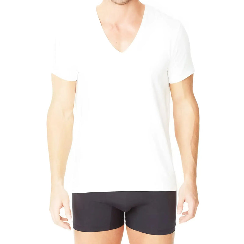 Man standing wearing plain white V-neck shirt and dark underwear.