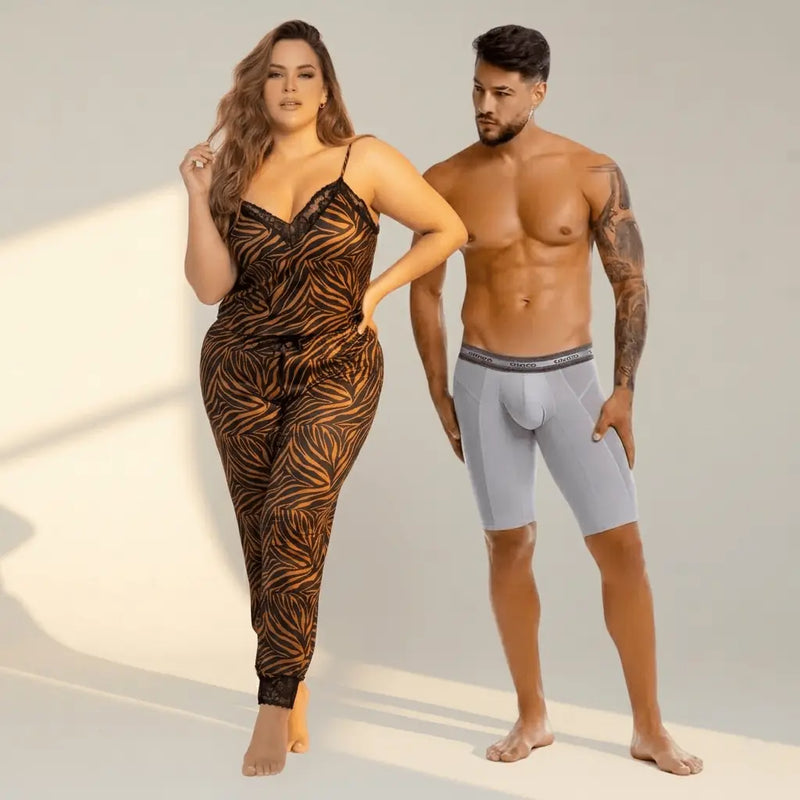 The woman is wearing a black and orange leaf patterned pajama set with lace trim from SeductiveUtopiaAPAC.com plus size fashion.