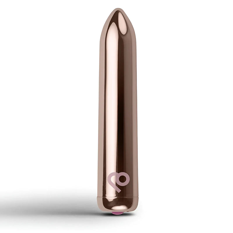 A polished rose gold bullet-shaped object stands upright against a white background.
