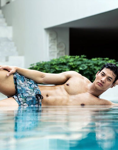 Men’s swim trunks with a blue and green abstract pattern from the swim shorts and trunks collection