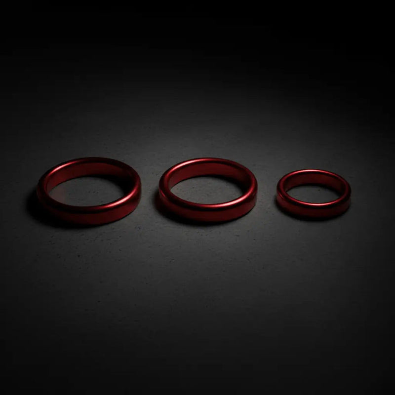 Three red metallic rings of varying sizes arranged in a row in the si novelties collection