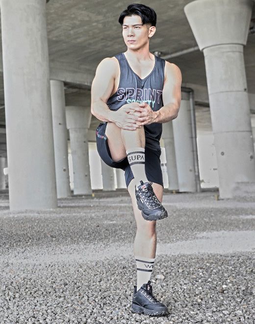 Black athletic shoe with thick soles and laces in a men’s socks collection front view