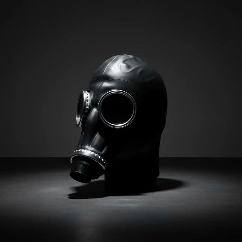 Black rubber gas mask with metallic silver-rimmed eye and mouthpiece openings from xtrm adult toys collection.