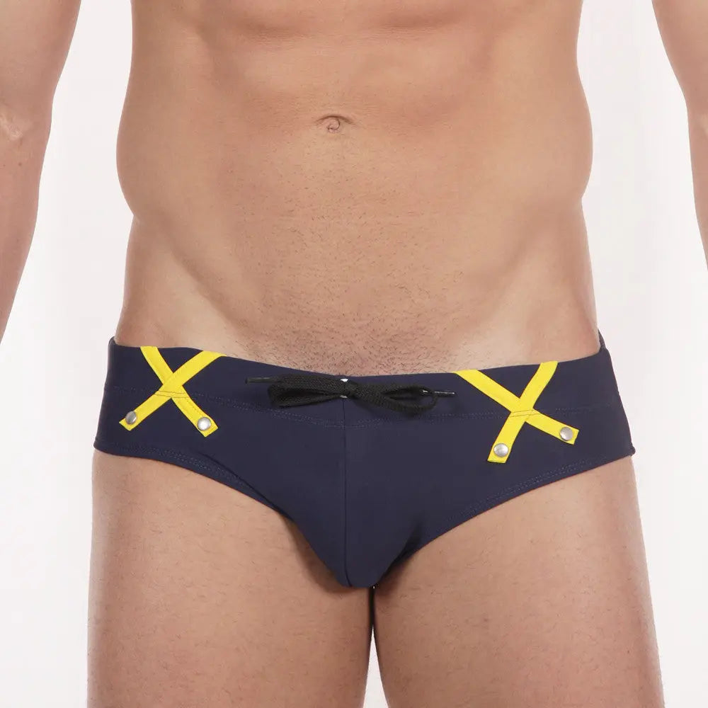 Navy briefs with yellow crossed straps at the hips.