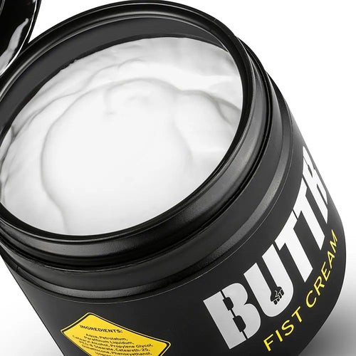 Open black tub filled with white cream.