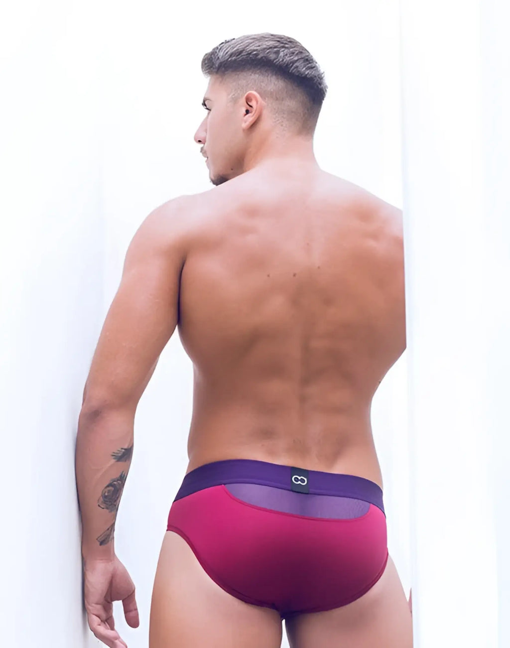 A man wearing 2eros aktiv cronus brief underwear beet red with burgundy purple mesh athletic sides