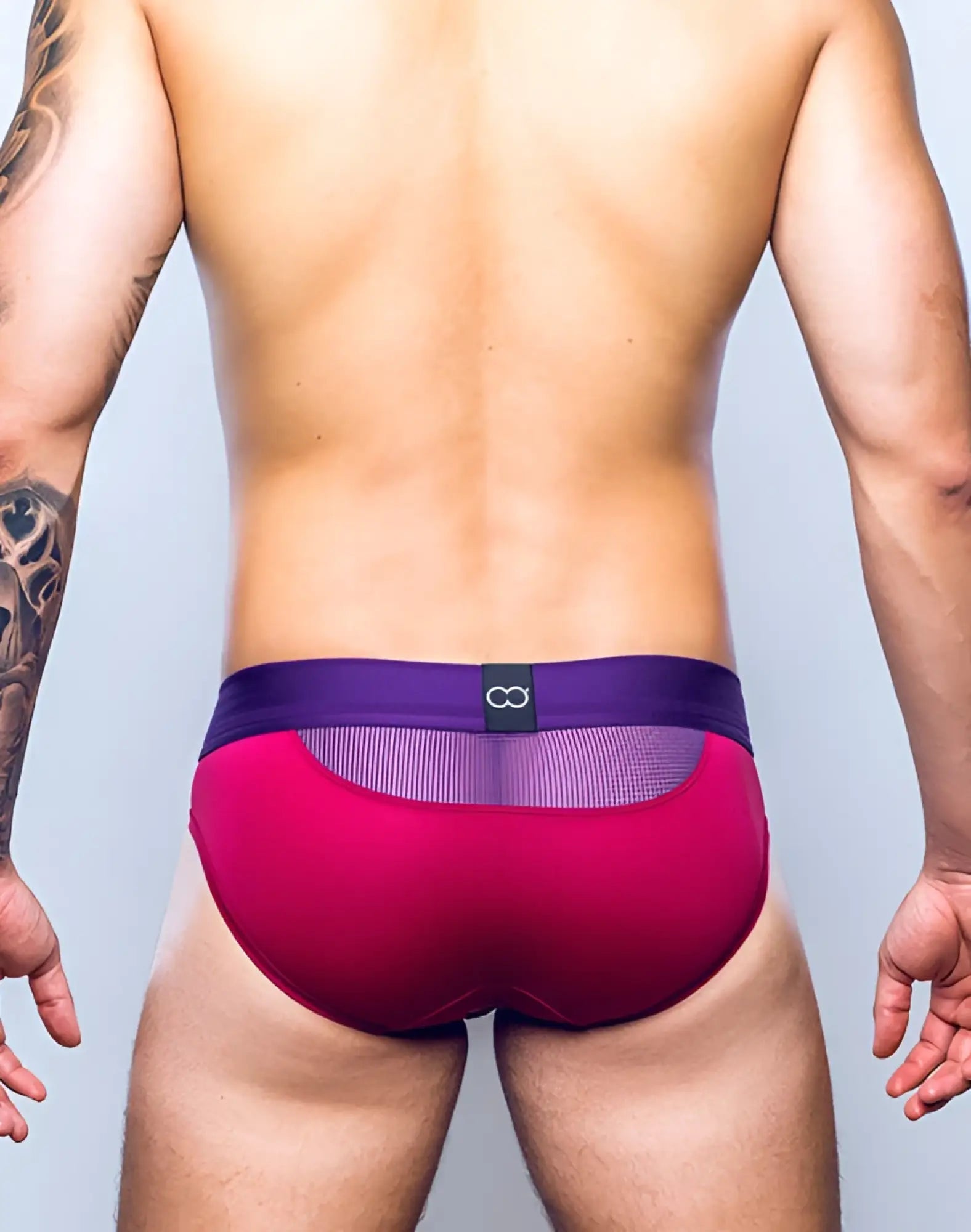 Back of 2eros aktiv cronus brief underwear in beet red with vibrant magenta and purple mesh panel and infinity logo
