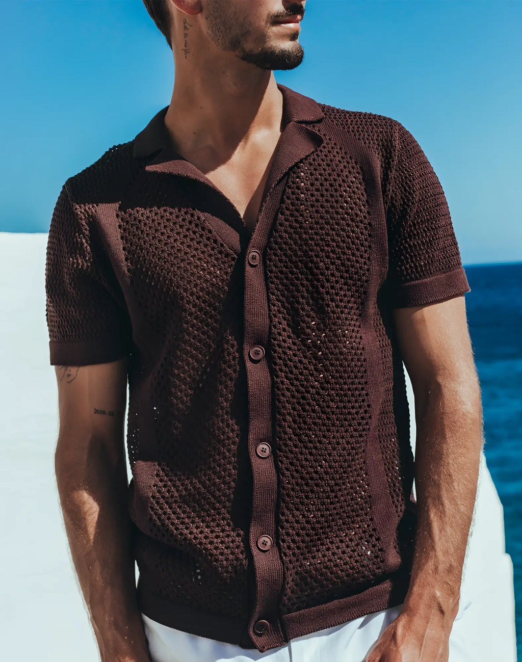 Brown knitted short-sleeved cardigan with textured openwork pattern and buttons paired with 2EROS amalfi shirt carbon black