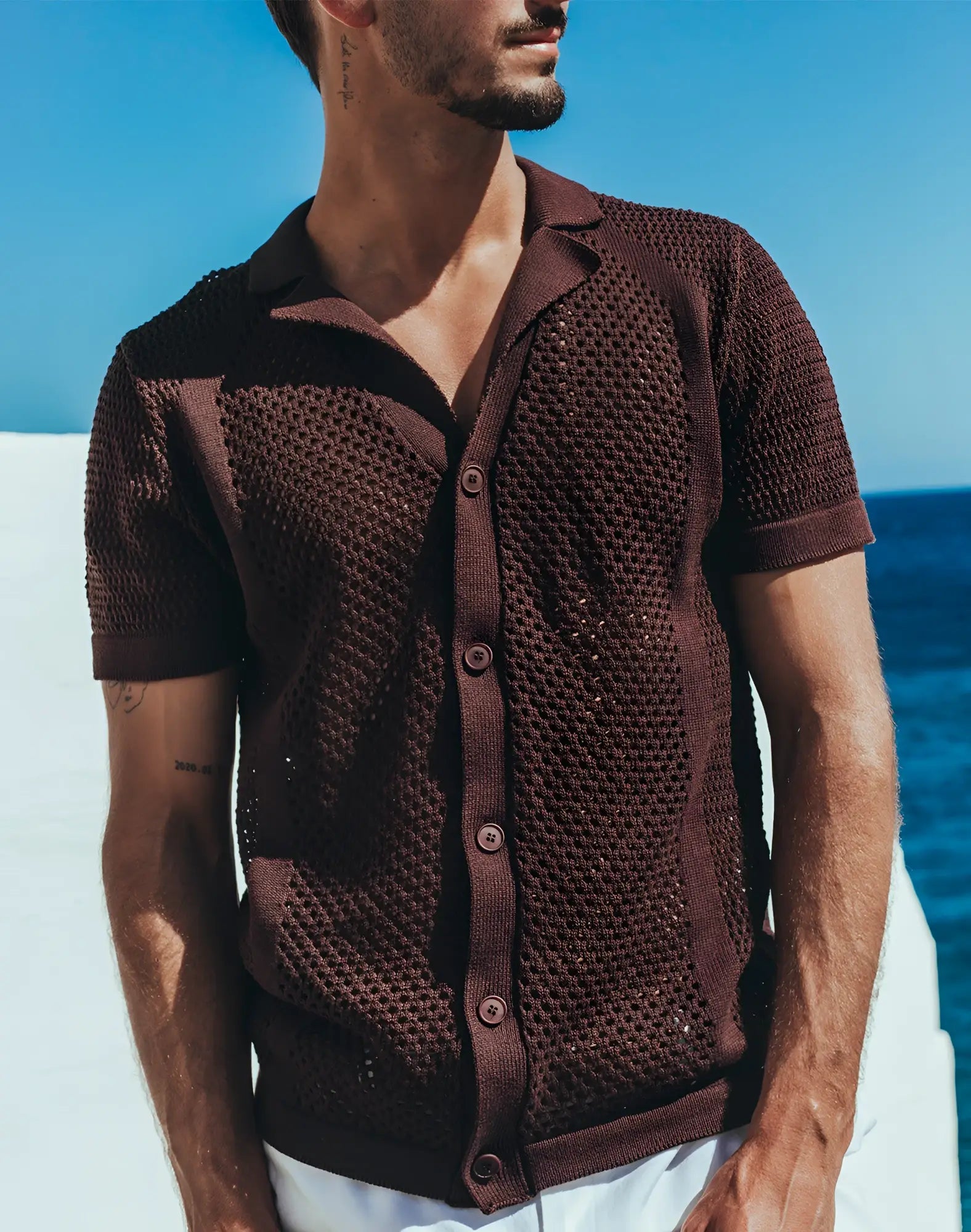 Brown knitted short-sleeved cardigan with textured openwork pattern and buttons paired with 2EROS amalfi shirt carbon black