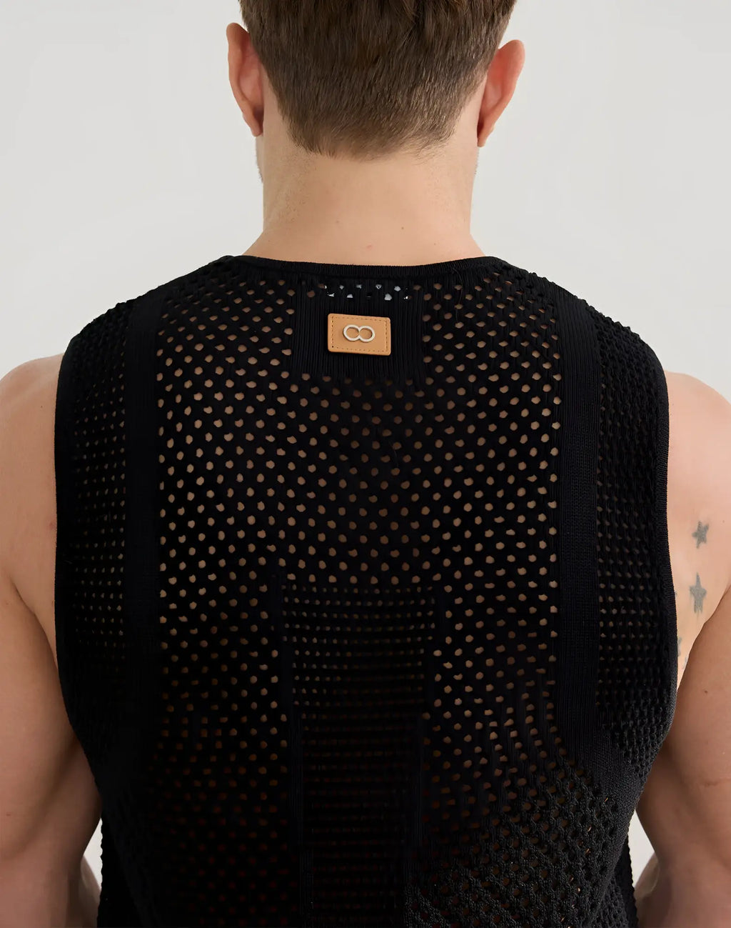 Black 2EROS Amalfi singlet sleeveless top in mesh knit with subtle pattern and tan leather patch at neckline