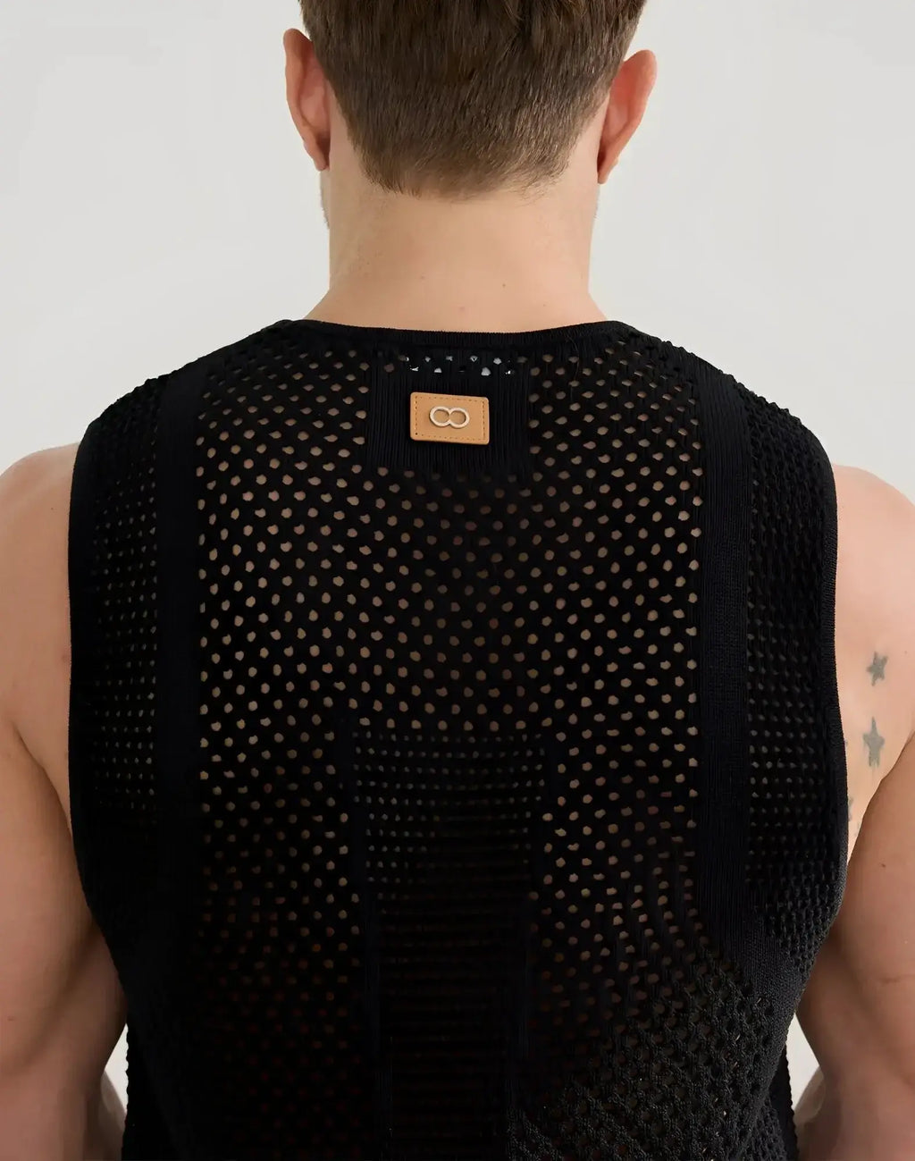 Black 2EROS Amalfi singlet sleeveless top in mesh knit with subtle pattern and tan leather patch at neckline