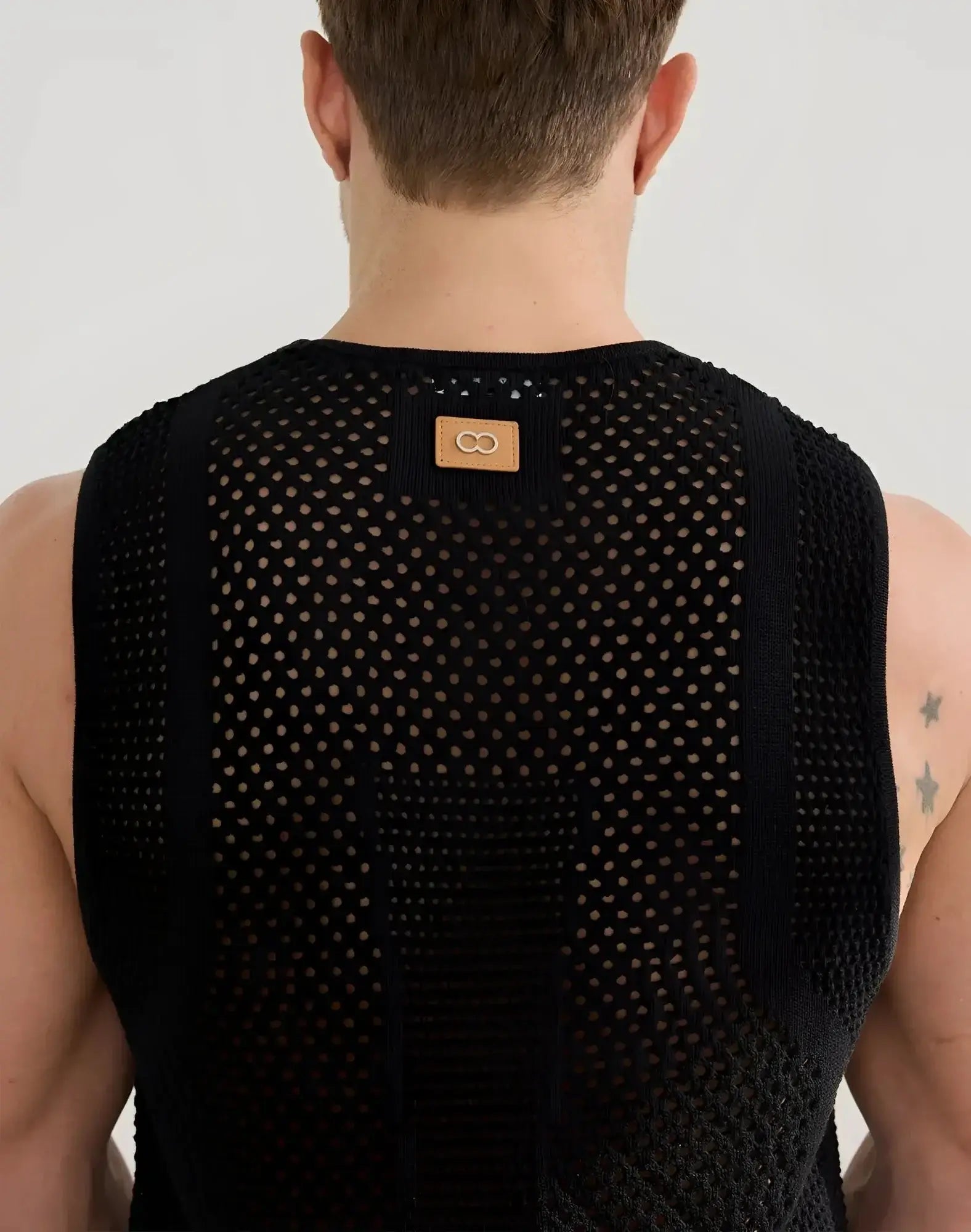 Black 2EROS Amalfi singlet sleeveless top in mesh knit with subtle pattern and tan leather patch at neckline