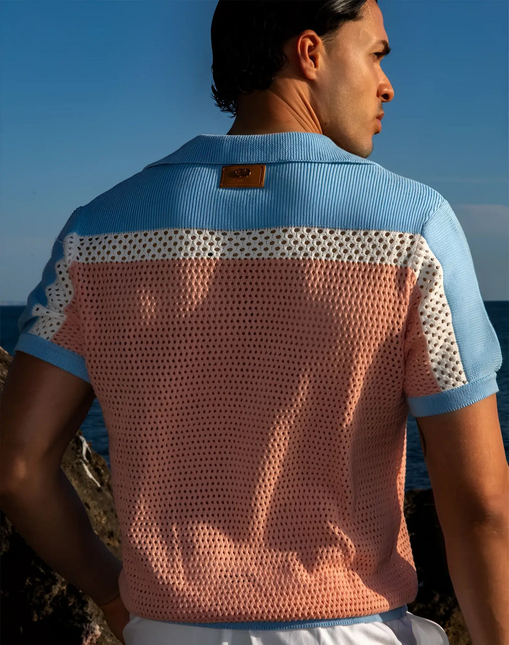 Back view of 2EROS Aruba polo in pink and blue knit with perforated mesh pattern short sleeves and ribbed collar