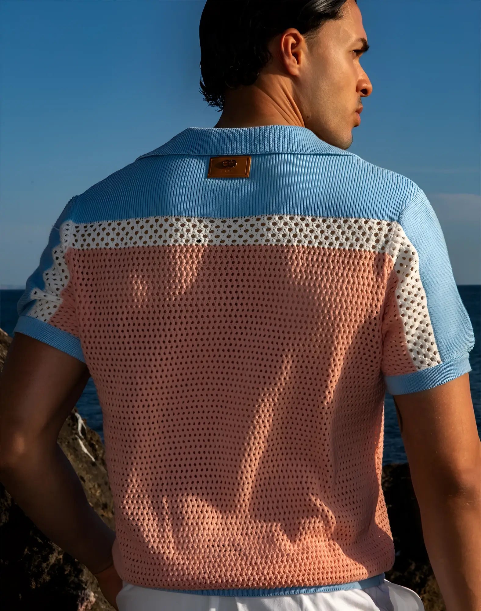 Back view of 2EROS Aruba polo in pink and blue knit with perforated mesh pattern short sleeves and ribbed collar