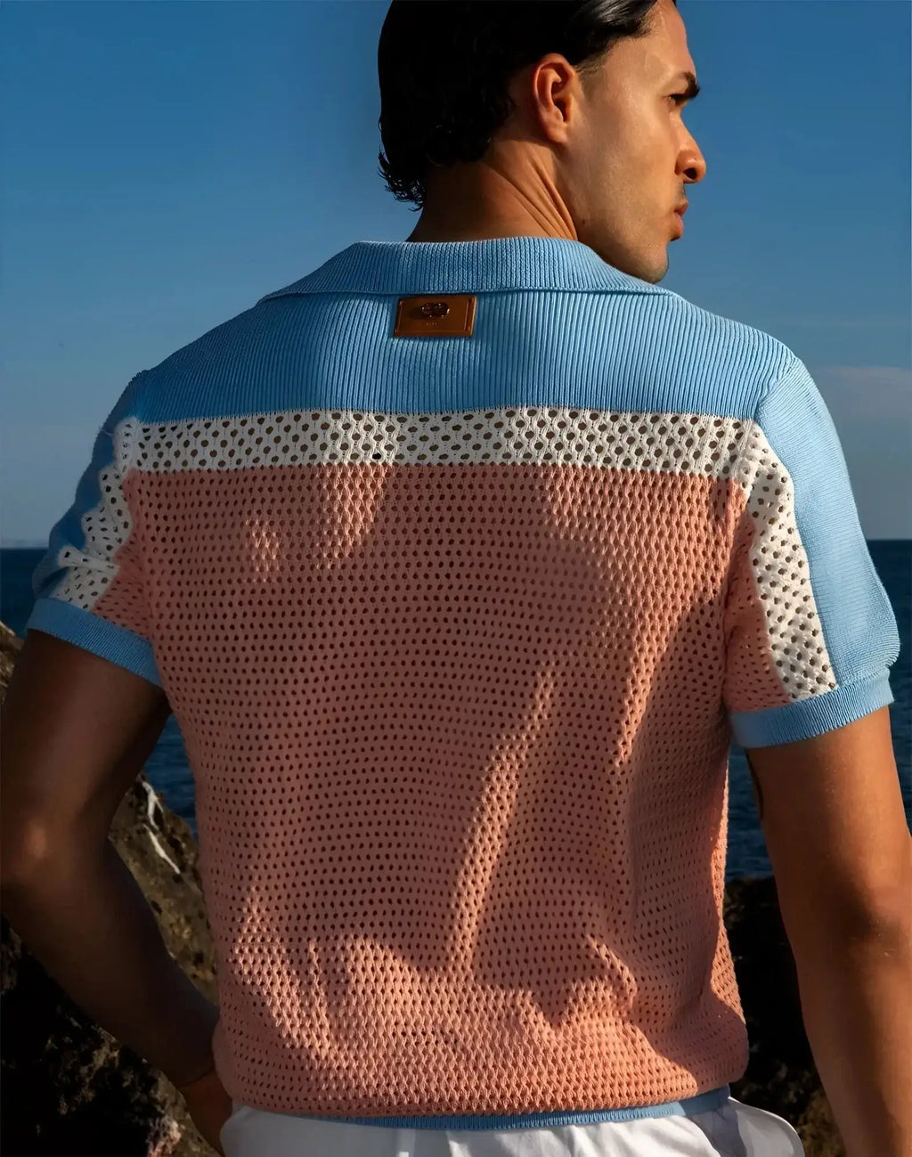Back view of 2EROS Aruba polo in pink and blue knit with perforated mesh pattern short sleeves and ribbed collar