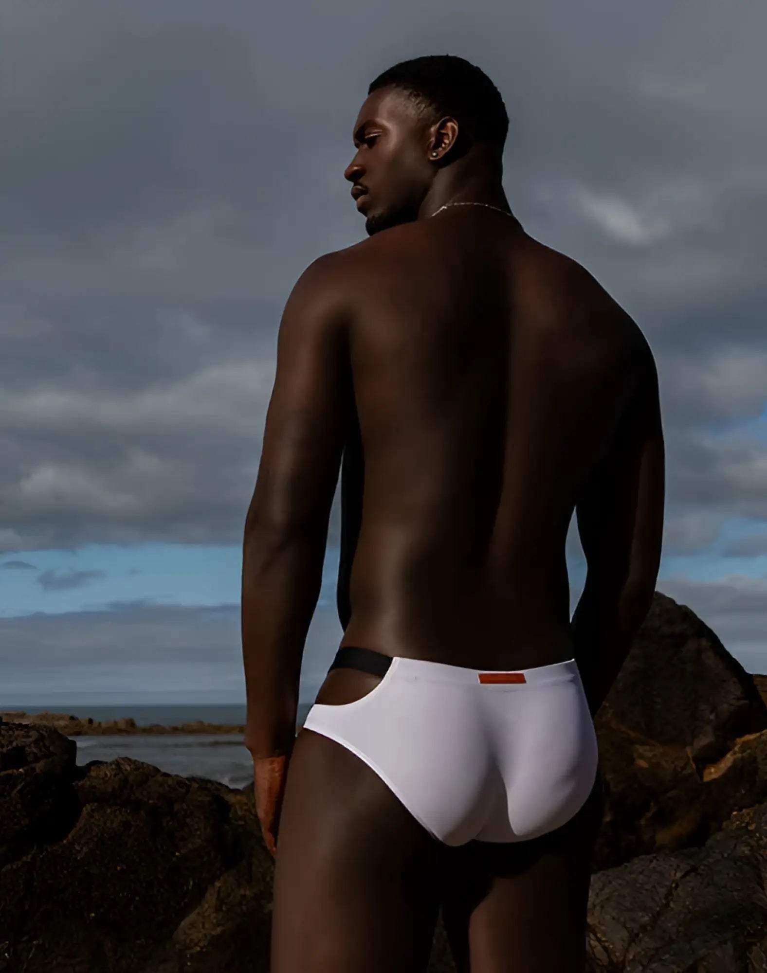 2EROS BLK Label No 5 swim brief in black and white with black side panels and an orange waistband tag