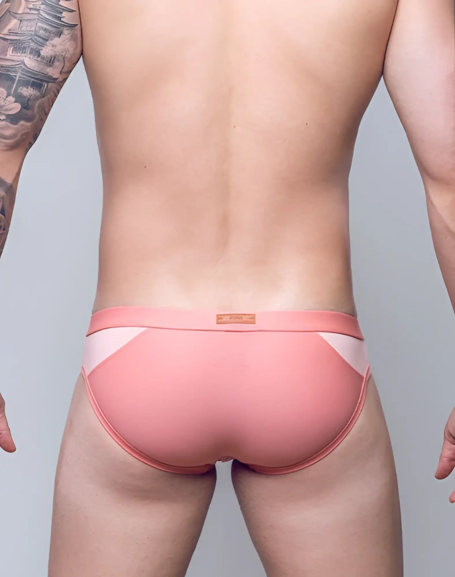 Pink 2EROS BLK Label No.6 swim brief with white geometric paneling and subtle brand tag at the waistband