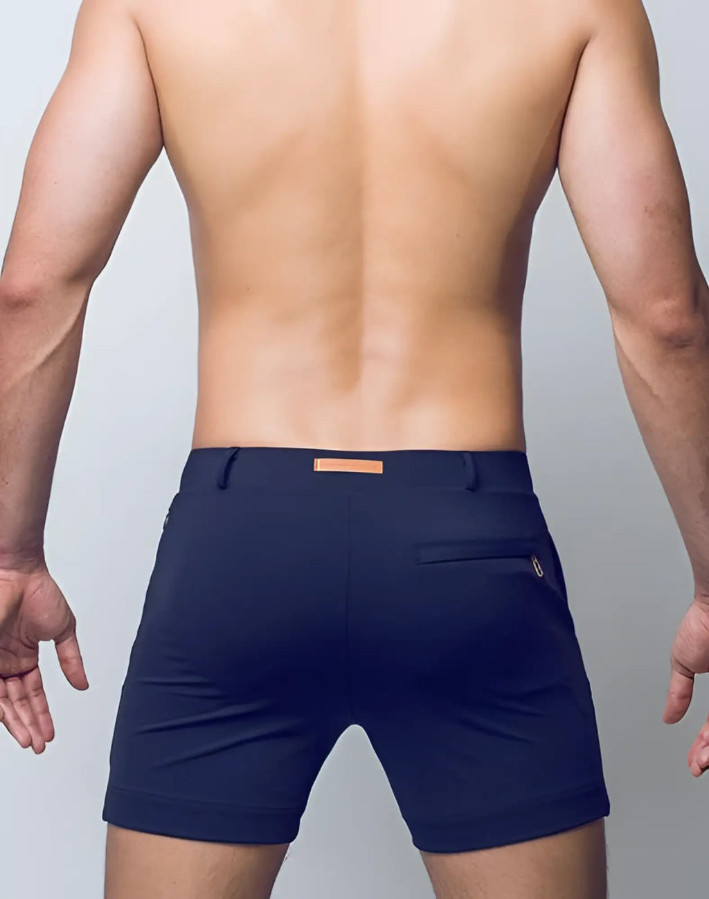 Back view of 2EROS Bondi Shorts Series 3 black tailored navy blue shorts with subtle orange belt loop and gold zipper detail