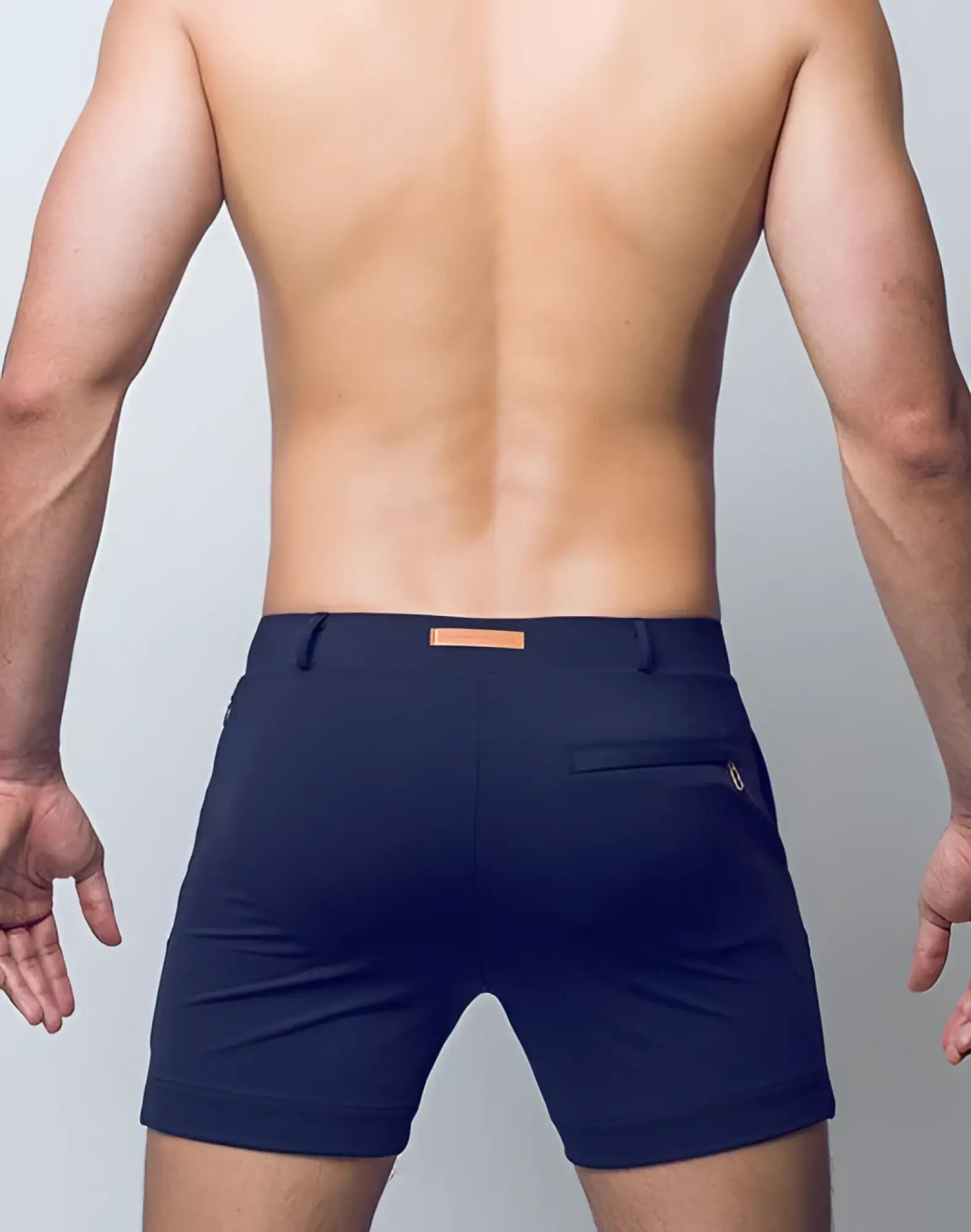 Back view of 2EROS Bondi Shorts Series 3 black tailored navy blue shorts with subtle orange belt loop and gold zipper detail