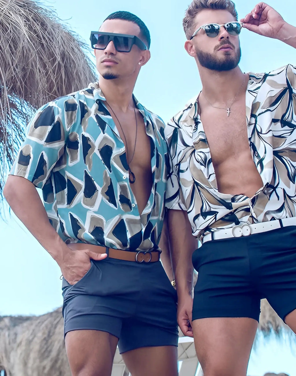 Two men wearing 2EROS Bondi shorts series 3 in charcoal with patterned teal black and beige short-sleeved shirts