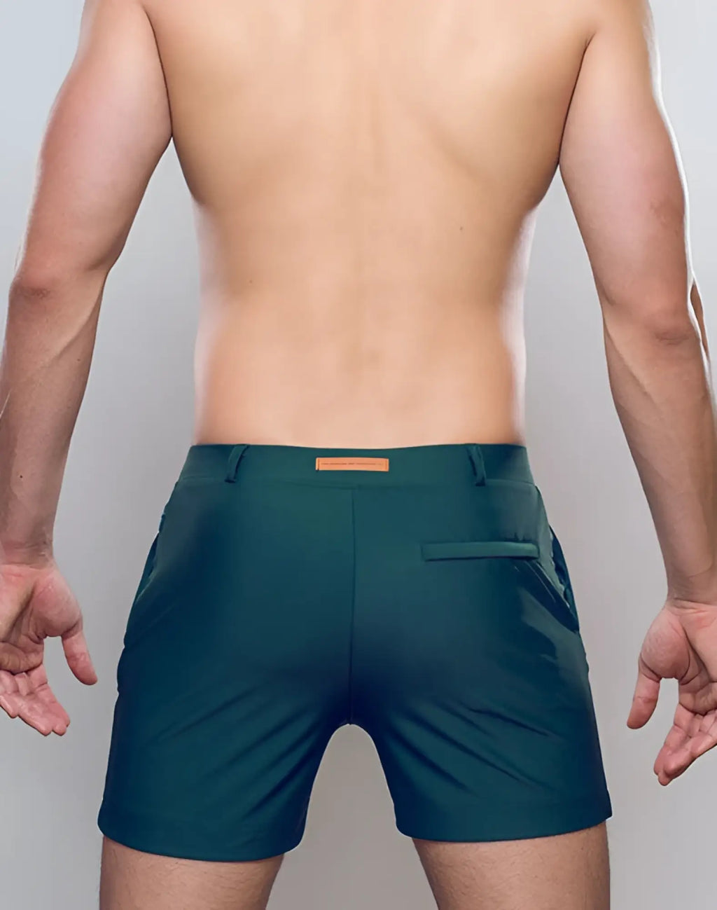 Dark green 2eros bondi athletic shorts with subtle sheen and orange leather-like brand tag at waistband