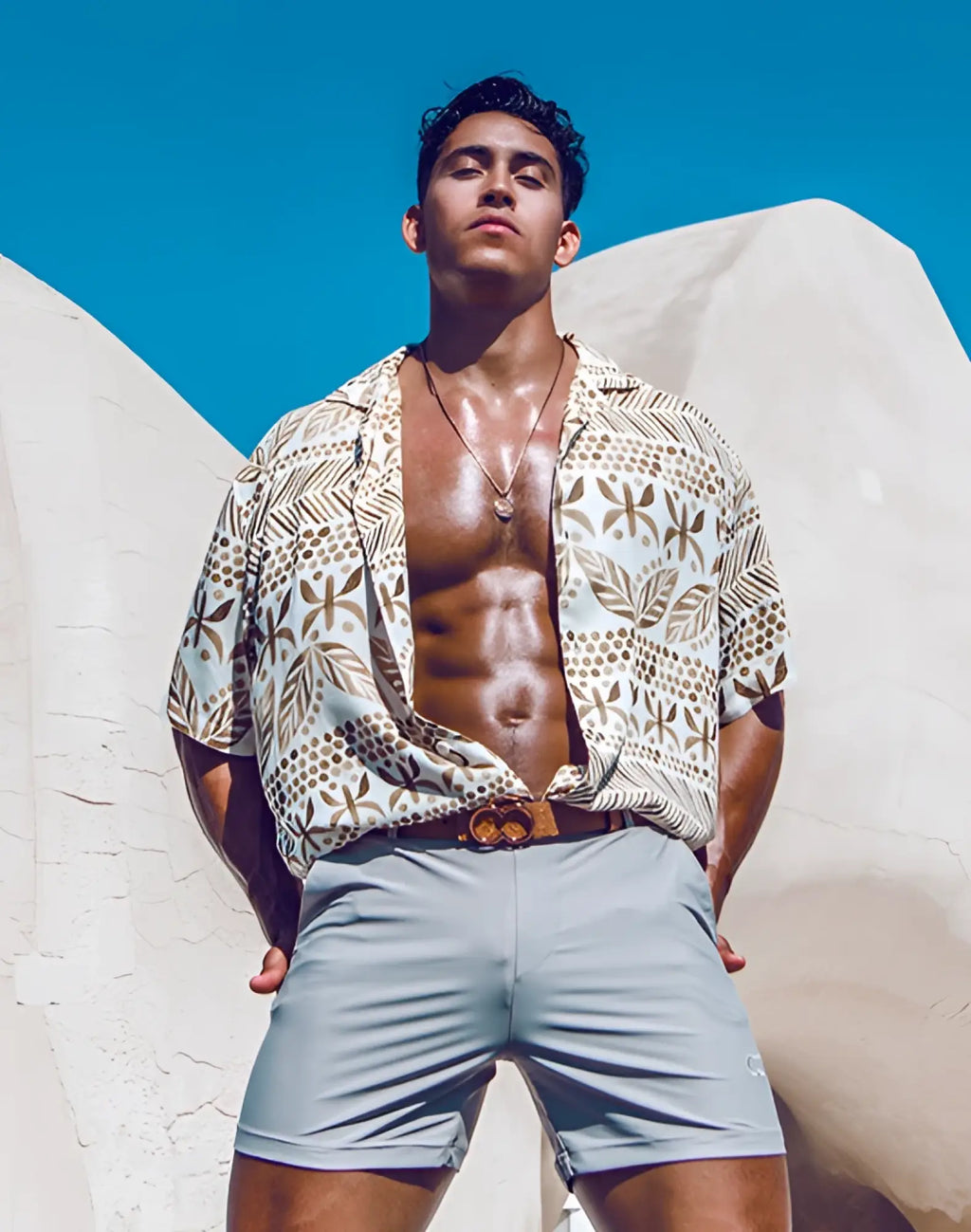Beige and brown patterned short-sleeved button-up shirt with leaf and dot motifs paired with 2EROS Bondi shorts string brown